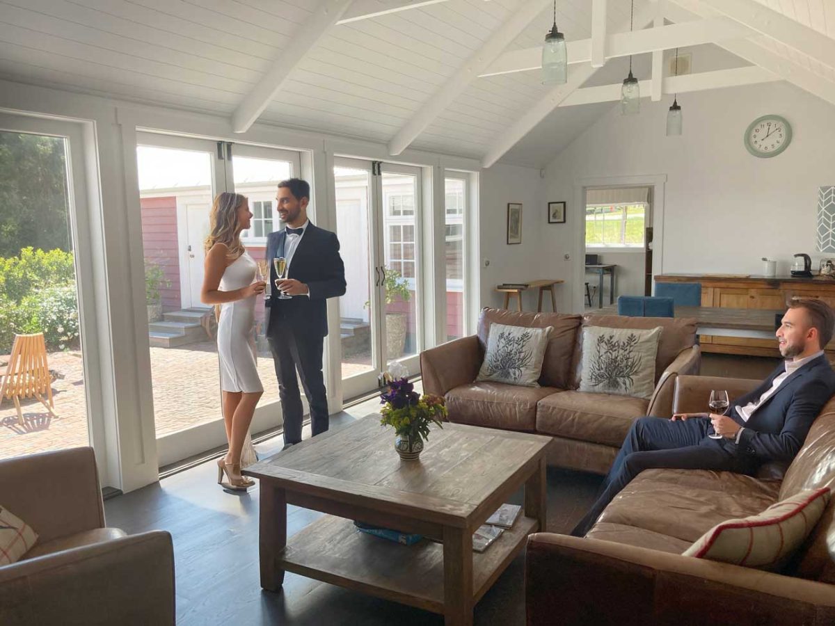 Guests relaxing in the main living area of The Red Barns West Wing, Tai Tapu, Canterbury, New Zealand before a wedding or special event