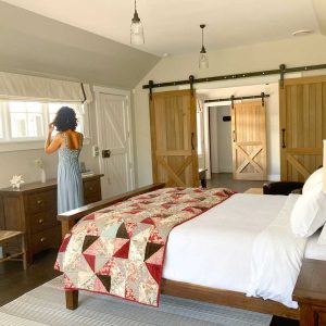 The Red Barns B&B courtyard in Tai Tapu, Canterbury, New Zealand, shown with guests relaxing prior to attending a special event. The outdoor space provides a tranquil and comfortable setting for socializing near Christchurch.